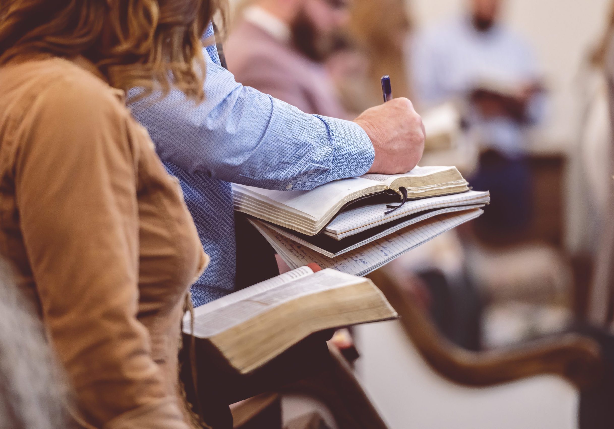 The church choir members holding sheet music and singing during a rehearsal