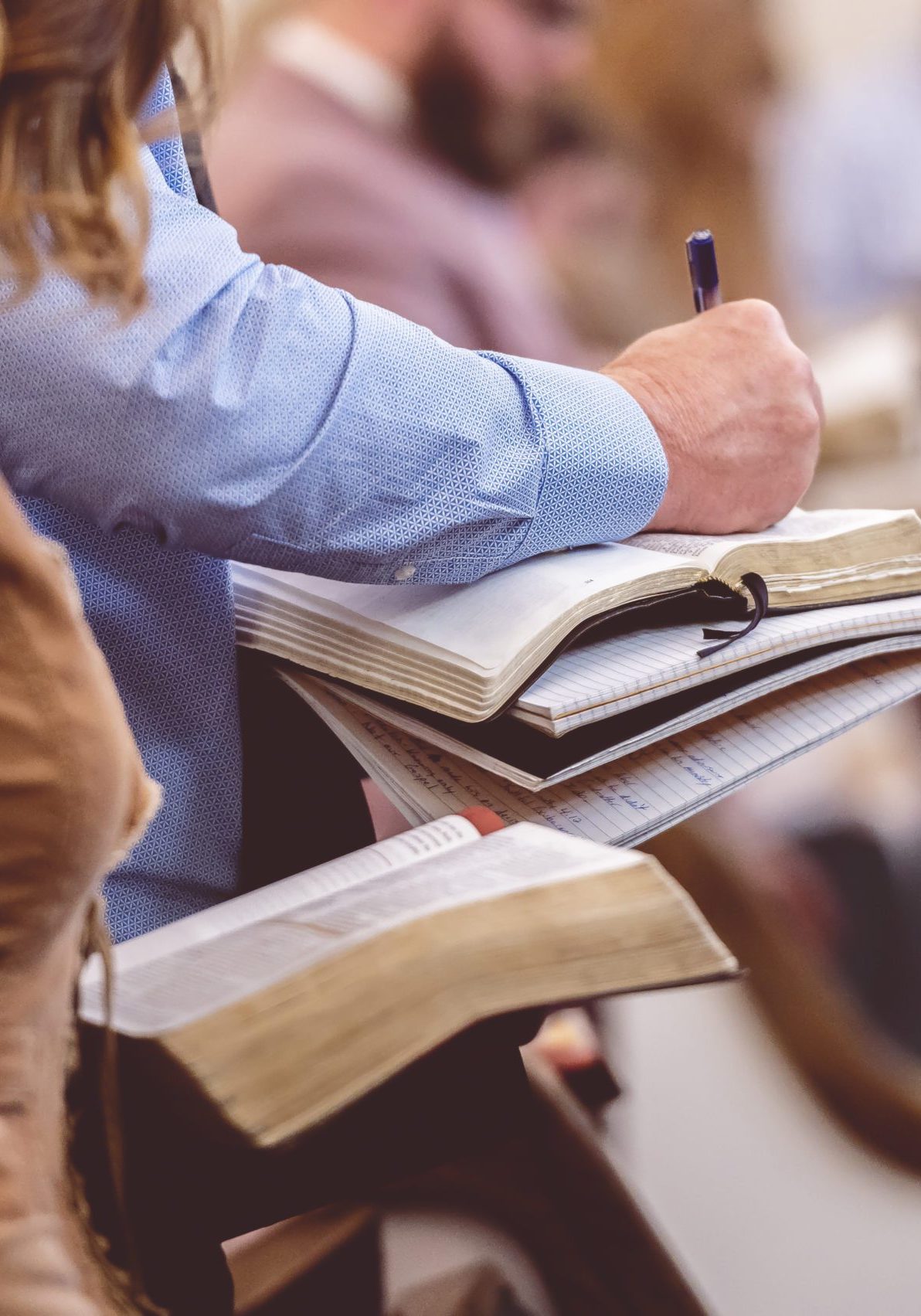 The church choir members holding sheet music and singing during a rehearsal